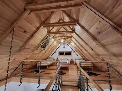 a room in a cabin with wooden ceilings at Antić apartmani Stara planina in Crni Vrh