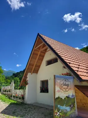 a small white house with a red roof at Antić apartmani Stara planina in Crni Vrh