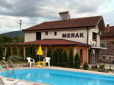 a hotel with a swimming pool in front of a merrak building at MERAK STD in Vranje