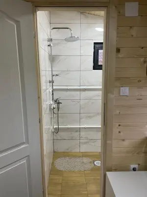 a shower with a glass door in a bathroom at MERAK STD in Vranje