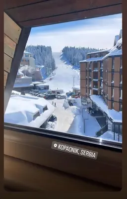 a view of a snow covered street from a window at Angella Kopaonik in Kopaonik