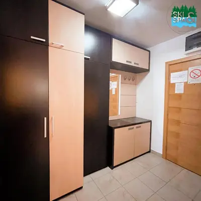 a room with a kitchen with a counter and a door at SKI & SPA Apartment in ZONED in Kopaonik