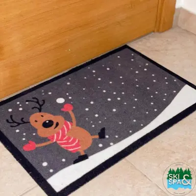 a rug with a teddy bear on a floor at SKI & SPA Apartment in ZONED in Kopaonik