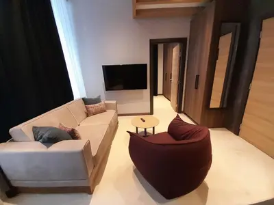 a living room with a couch and a chair at Woodside Kopaonik AAC in Raška