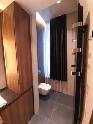 a small bathroom with a toilet and a window at Woodside Kopaonik AAC in Raška