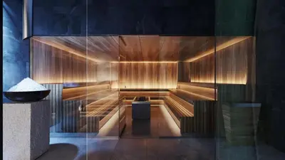a sauna with wood paneling and a glass wall at Woodside Kopaonik AAC in Raška