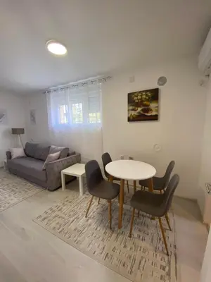 a living room with a table and chairs and a couch at Eleni in Vrnjačka Banja