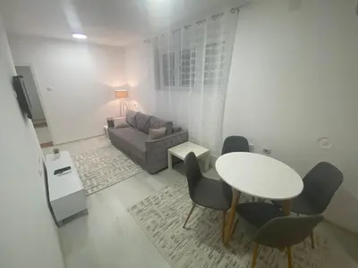 a living room with a table and a couch at Eleni in Vrnjačka Banja