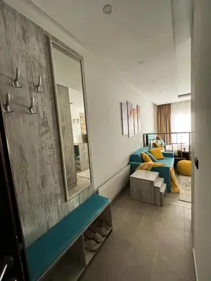 a room with a blue couch and a mirror at Milmari Golden N LUX 62 in Kopaonik