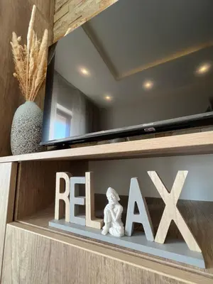 a shelf with a rex sign and a statue at Milmari Golden N LUX 62 in Kopaonik