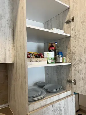 an open refrigerator with plates and food in it at Milmari Golden N LUX 62 in Kopaonik