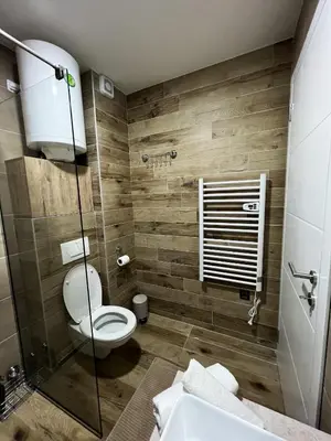 a bathroom with a toilet and a sink at Milmari Golden N LUX 62 in Kopaonik