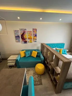 a living room with a blue couch and a table at Milmari Golden N LUX 62 in Kopaonik