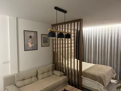 a living room with a couch and a crib at Gencian Resort KOPAONIK in Kopaonik