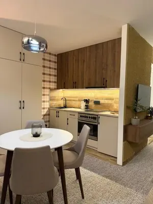 a kitchen with a white table and chairs at Gencian Resort KOPAONIK in Kopaonik