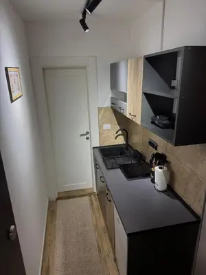 a kitchen with a black counter top and a door at Gencian Resort KOPAONIK in Kopaonik