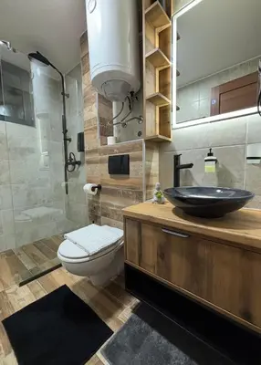 a bathroom with a sink and a toilet and a shower at Gencian Resort KOPAONIK in Kopaonik