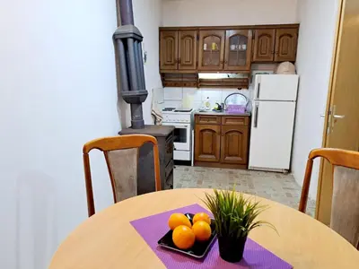 a kitchen with a table with oranges on it at Apartmani LEON Brzeće/Apartmens LEON Brzece in Brzeće