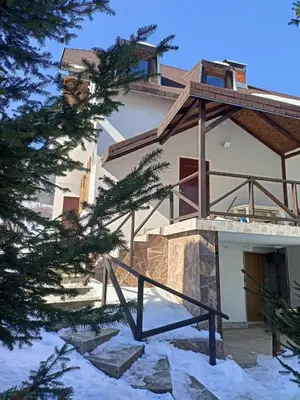a house in the snow with a balcony at Apartmani LEON Brzeće/Apartmens LEON Brzece in Brzeće