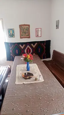 a table with a vase with flowers on it at Oko Jastrepca in Veliko Krušince