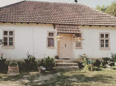 a white house with a tiled roof at Oko Jastrepca in Veliko Krušince