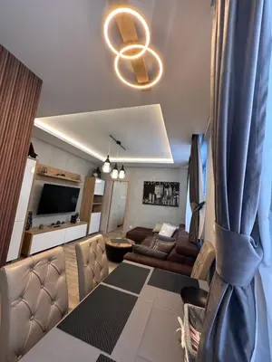 a living room with a couch and a tv at Apartman 3 - Vila Montana in Kopaonik