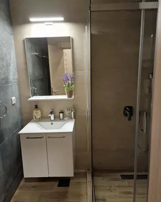 a bathroom with a sink and a shower at Apartman 3 - Vila Montana in Kopaonik