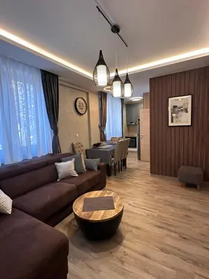 a living room with a couch and a table at Apartman 3 - Vila Montana in Kopaonik
