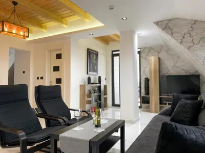 a living room with a couch and a table at Apartmani ANA - Kopaonik, Treska in Kopaonik