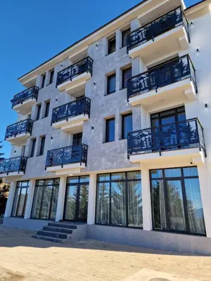 a building with balconies on the side of it at Apartmani ANA - Kopaonik, Treska in Kopaonik