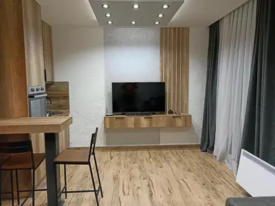 a living room with a flat screen tv on a wall at Apartmani ANA - Kopaonik, Treska in Kopaonik