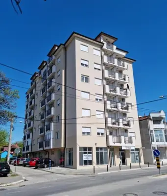 a tall apartment building on a city street at Bili in Paraćin