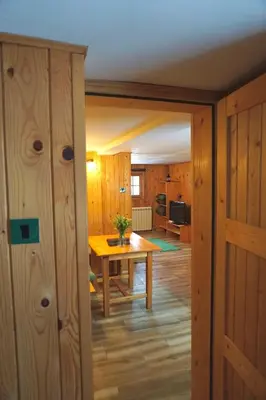 a dining room with a table and a kitchen at Montana Apartment in Kopaonik