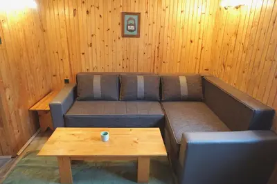 a living room with a couch and a coffee table at Montana Apartment in Kopaonik