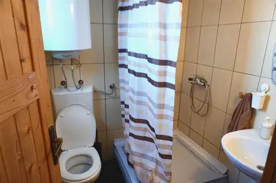 a small bathroom with a toilet and a sink at Montana Apartment in Kopaonik