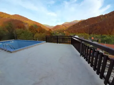 a deck with a swimming pool on top of a mountain at Vila Kula in Crni Vrh