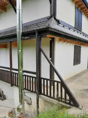 a porch of a house with a wooden railing at Vila Kula in Crni Vrh