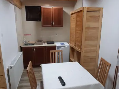 a kitchen with a table with a remote control on it at Vila Kula in Crni Vrh