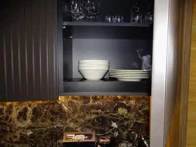 a cabinet with plates and bowls on a shelf at Woodside Kopaonik 212 in Kopaonik