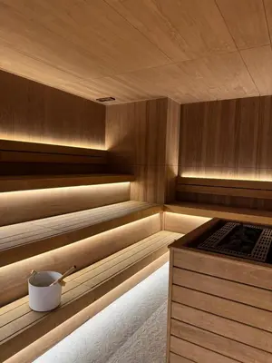 a sauna with a tub with a bucket in it at Woodside Kopaonik 212 in Kopaonik