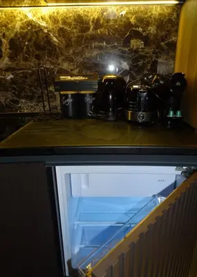a stove with pots and pans on top of it at Woodside Kopaonik 212 in Kopaonik