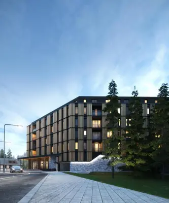 a large building with a tree in front of it at Woodside Kopaonik 212 in Kopaonik
