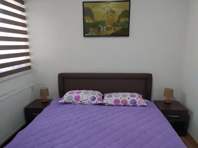 a bedroom with a purple bed with two pillows at ROSA in Vrnjačka Banja