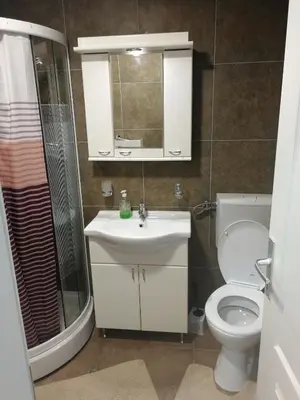 a bathroom with a toilet and a sink and a shower at ROSA in Vrnjačka Banja