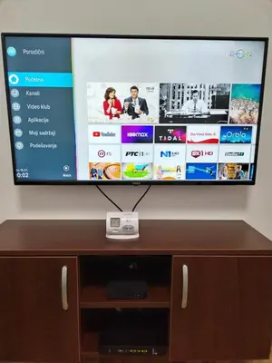 a flat screen tv sitting on top of a wooden cabinet at ROSA in Vrnjačka Banja