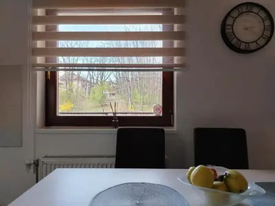 a bowl of fruit on a table with a window at ROSA in Vrnjačka Banja