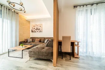 a living room with a couch and a table at Vision apartmani Vrnjačka Banja in Vrnjačka Banja