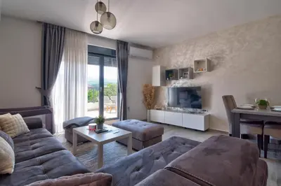 a living room with a couch and a table at Vision apartmani Vrnjačka Banja in Vrnjačka Banja