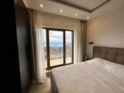 a bedroom with a bed and a large window at N Lux 81 - Milmari Resort in Kopaonik