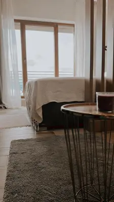 a bedroom with a bed and a table and a window at N Lux 81 - Milmari Resort in Kopaonik